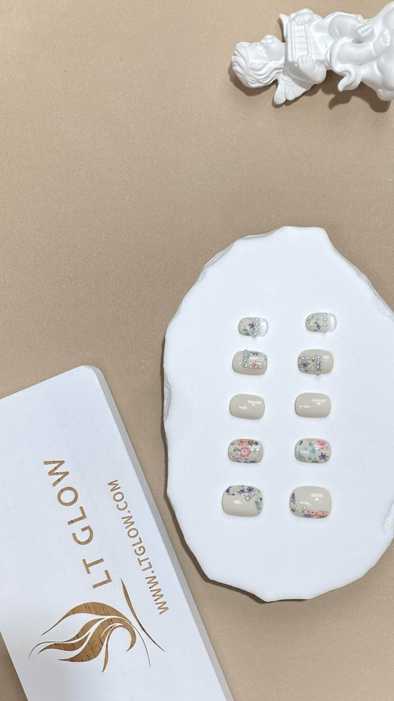 Handcrafted squoval fake nails from LT-Glow in pristine white, artistically hand-painted and highlighted with pearl designs