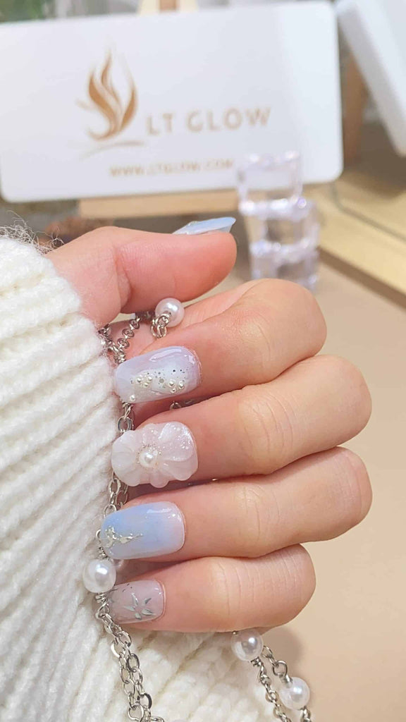 LT-Glow's elegant squoval press-on nails in shades of white and blue, adorned with pearls and flower charms for a refined touch