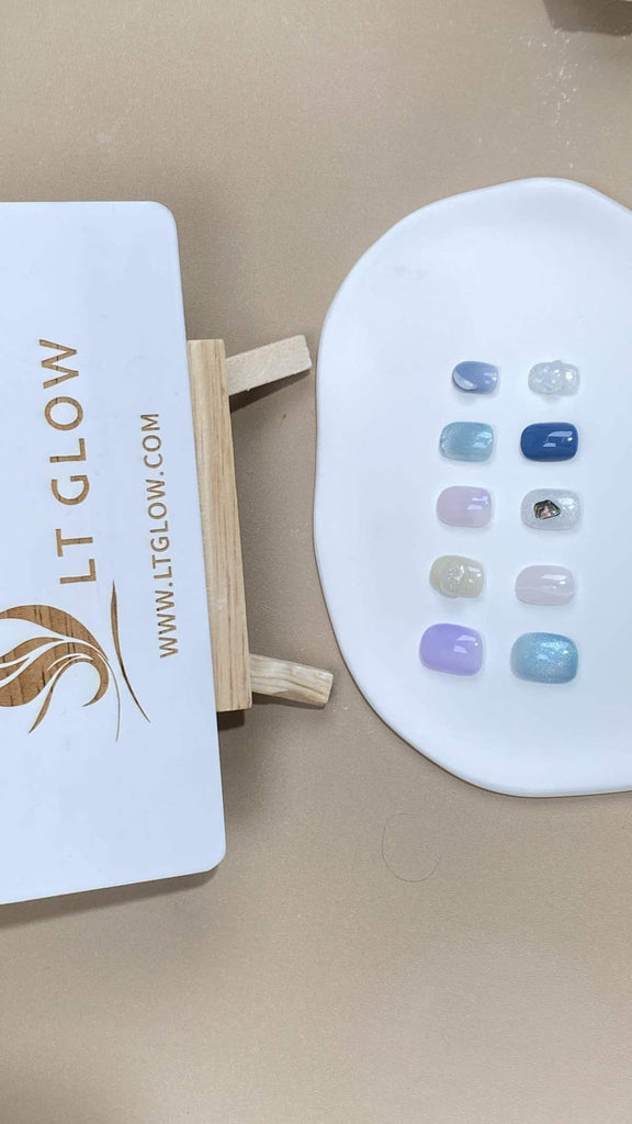 Handcrafted squoval fake nails from LT-Glow showcasing a serene blend of white and blue, accentuated with luminous crystals