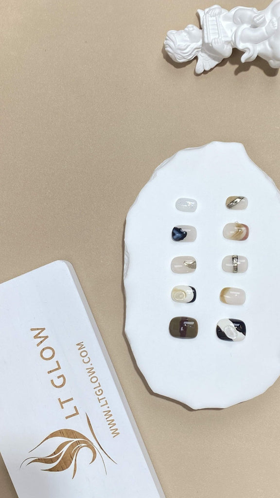 Handcrafted squoval artificial nails from LT-Glow, showcasing a harmonious fusion of white, nude, and brown, adorned with subtle charms
