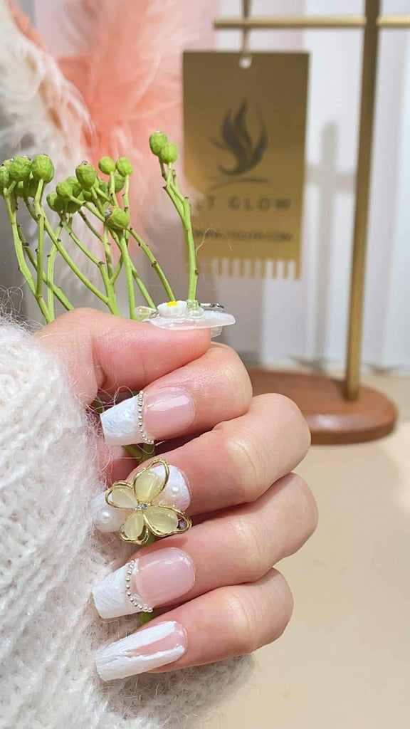 Elegant coffin-shaped press-on nails by LT-Glow, adorned with butterfly and flower charms in a white and nude palette, complemented with pearl accents