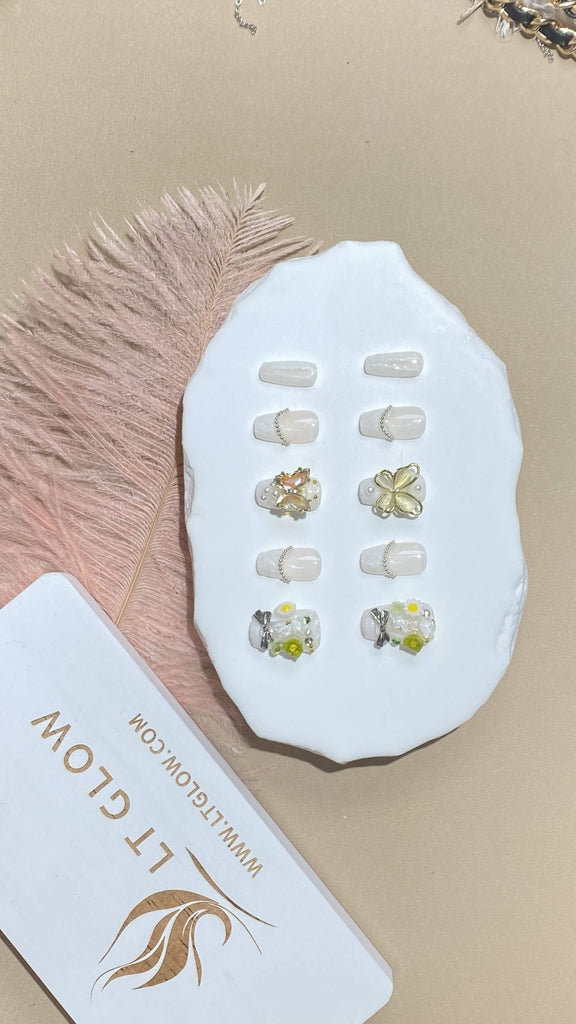 LT-Glow's handcrafted coffin fake nails, featuring a harmonious blend of white and nude, embellished with butterfly motifs, flowers, and lustrous pearls