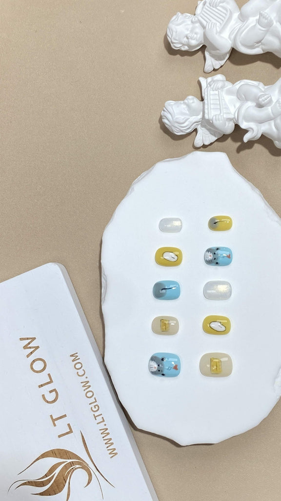 Squoval-styled fake nails from LTGlow, showcasing a vibrant blend of yellow and blue, enhanced by delightful mouse designs and sparkling glitter accents