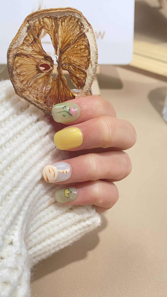 Handmade squoval press-on nails by LTGlow, showcasing a vibrant interplay of yellow and green, adorned with intricate tiger motifs and delicate flower patterns