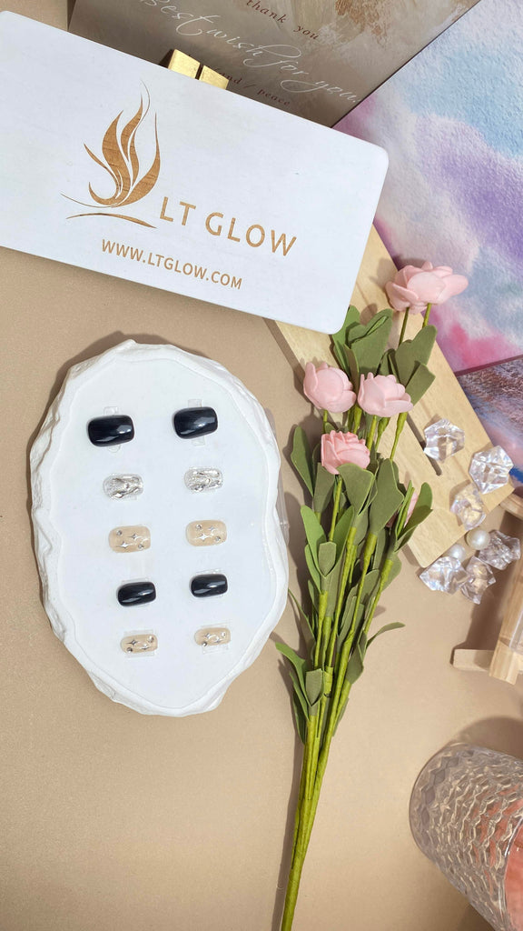 LT Glow's squoval-shaped press-on nails in an enchanting blend of black and brown, adorned with star, diamond, and crystal accents for a stylish and handcrafted look.
