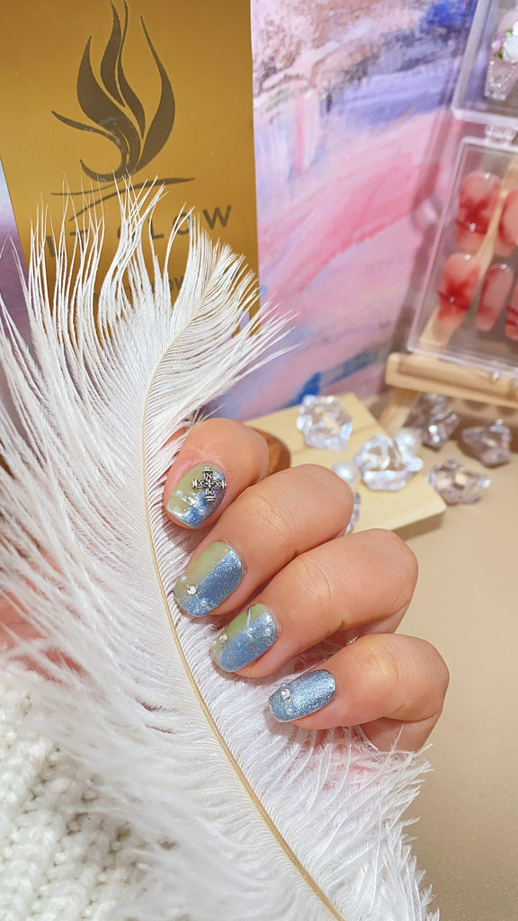 Elegant fake nails by LT Glow, featuring a meticulously handcrafted round design in a captivating blue and green palette, enriched with captivating hand-painted details, diamond, crystal, glitter, and pearl elements.
