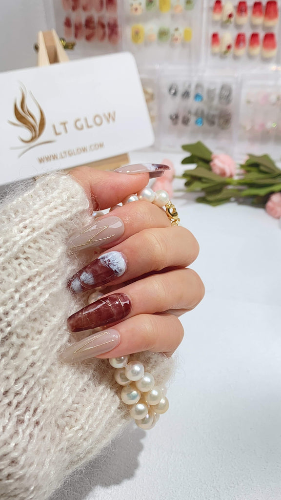 LT Glow's handcrafted coffin-shaped press-on nails, artistically hand-painted in shades of gray and brown