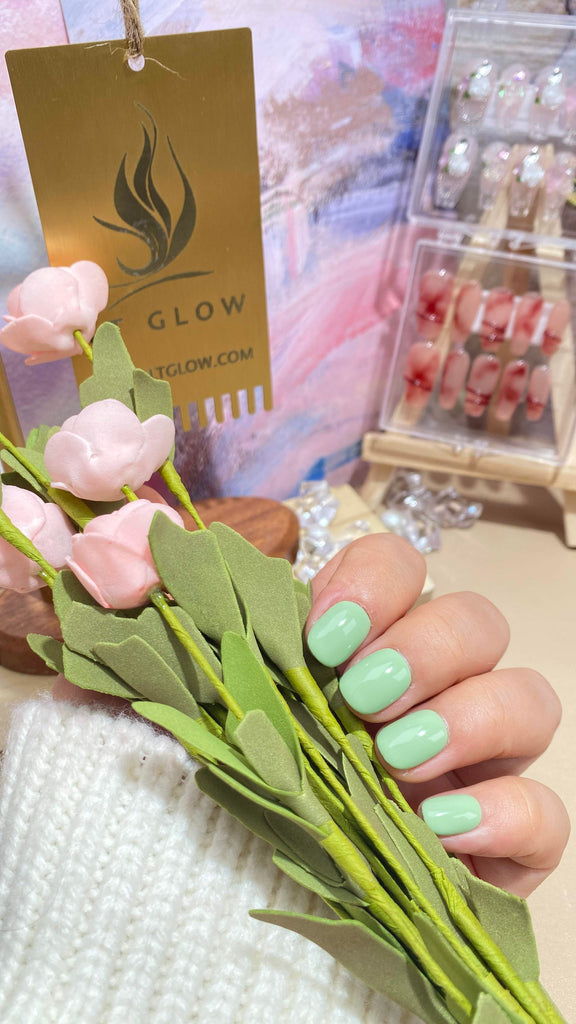 Elegant fake nails by LT Glow, offering a beautifully handcrafted round design in a refreshing green shade, providing a chic and natural look.