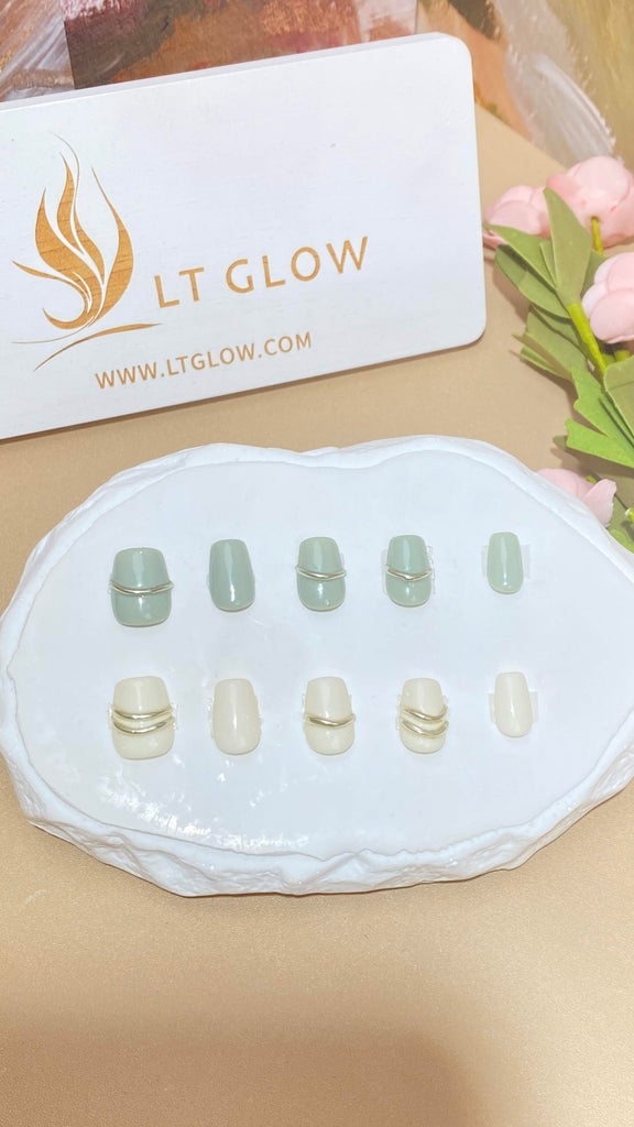 LT Glow's coffin-shaped press-on nails in a delightful blend of green and white, featuring charming details for a fresh and stylish look.