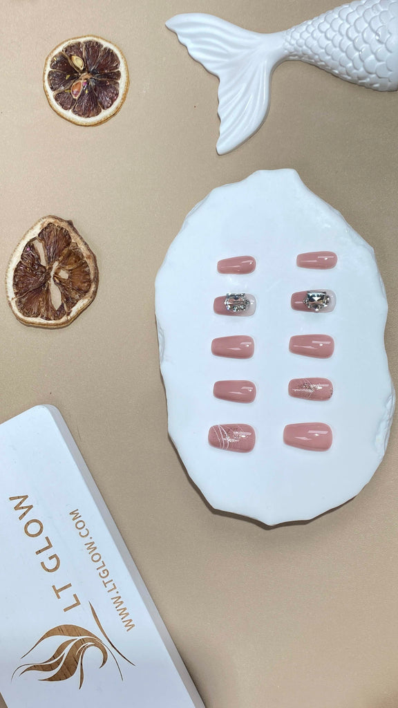 Exquisite pink fake nails by LT Glow, handcrafted in a coffin design, adorned with 3D elements, unique charms, and sparkling glitter
