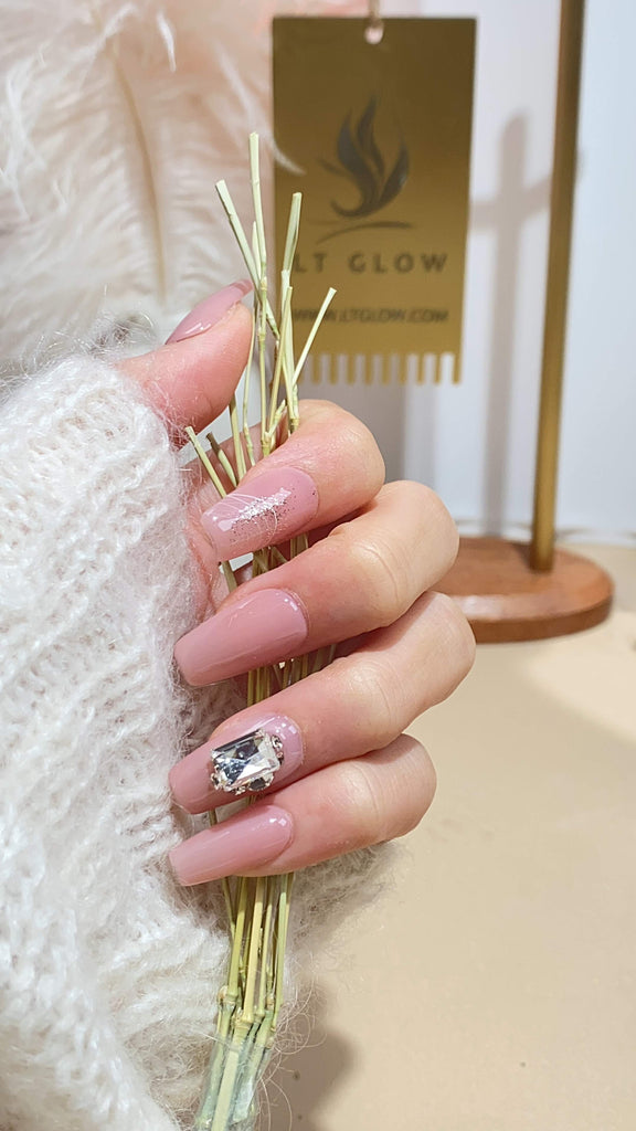 Hand-painted coffin-shaped press-on nails by LT Glow, capturing a radiant pink hue with 3D embellishments, charms, and glitter accents