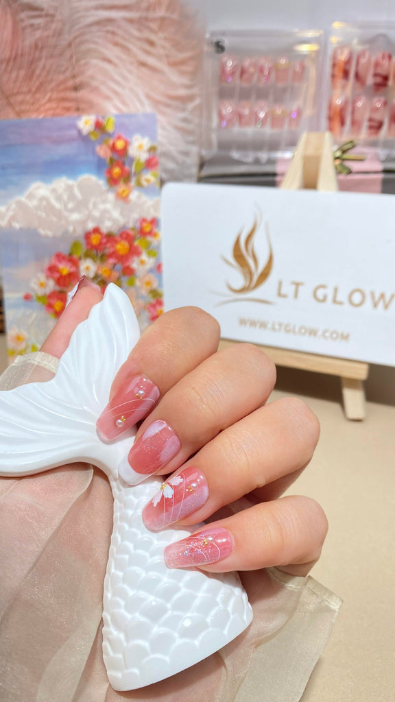 Delicate pink and white coffin nails showcasing hand-painted floral designs for a feminine touch