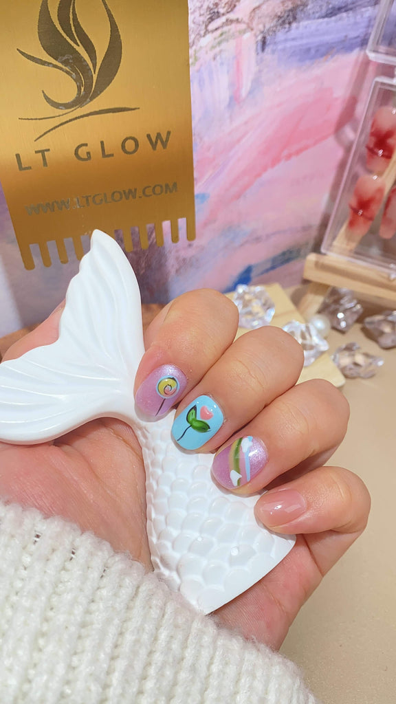 LT Glow's squoval-shaped press-on nails in a captivating blend of purple, blue, and nude, adorned with charming hand-painted horse and flower designs for a unique and artistic look.