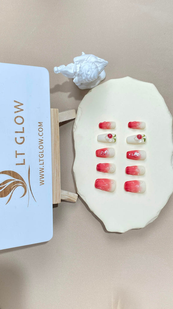 Revel in the luxurious combination of red and white in these coffin-styled fake nails. Embellished with sparkling diamonds, crystals, and 3D charms, they're a perfect expression of sophisticated acrylic nails design