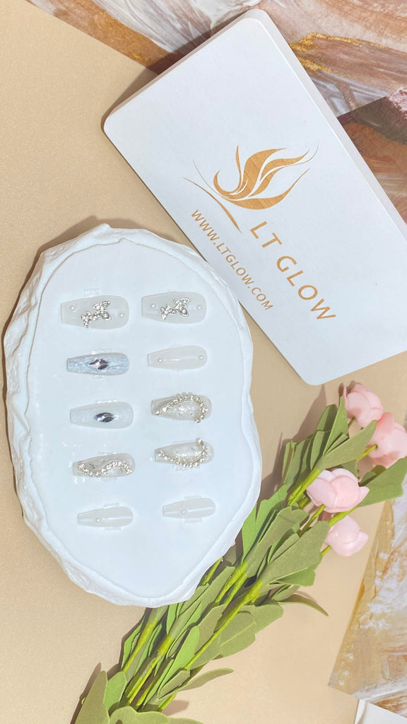 LT Glow's coffin-shaped press-on nails in elegant white, adorned with exquisite hand-painted butterfly designs, shimmering diamond and crystal accents, and lustrous pearl embellishments for a luxurious and artistic appearance.