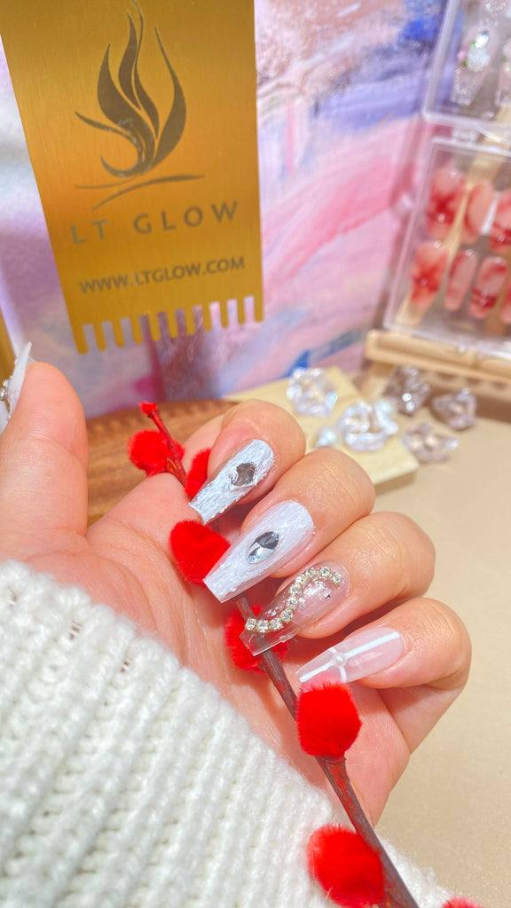 Handmade false nails from LT Glow, presenting a captivating coffin shape in white, complemented by intricate hand-painted butterfly artwork, brilliant diamond and crystal adornments, and elegant pearl accents, crafted with precision.