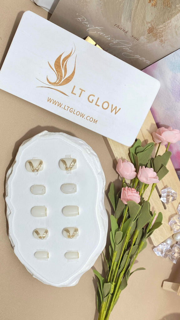 LT Glow's square-shaped press-on nails in a clean white hue, adorned with hand-painted pearl accents, showcasing a stylish and elegant look.