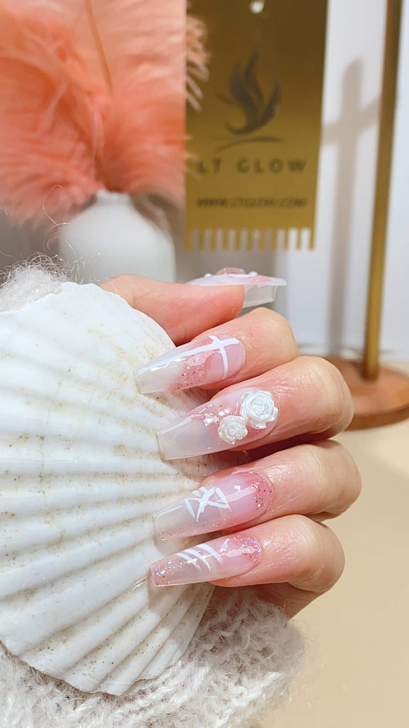 Elegant fake nails by LT Glow, featuring a blend of nude and blue with French bow, heart, and pearl embellishments, further enhanced with 3D elements and charms