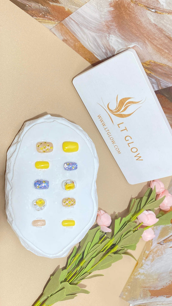 Elegant fake nails by LT Glow, showcasing a meticulously handcrafted squoval design in a captivating yellow and gold palette, enriched with sparkling diamond and crystal glitter.