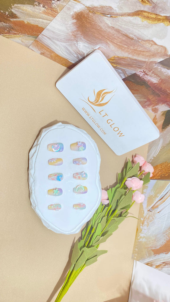 LT Glow's coffin-shaped press-on nails in a captivating blend of yellow and purple, adorned with star, moon, and butterfly hand-painted designs for a whimsical and artistic look.