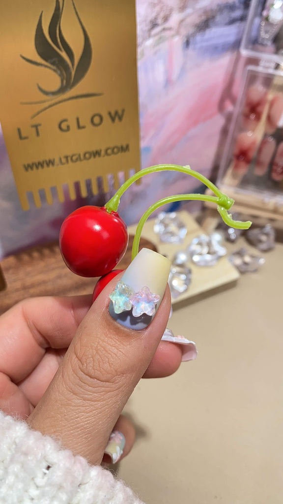 LT Glow's artistic coffin press-on nails in yellow and purple, showcasing a beautiful combination of hand-painted star, moon, and butterfly designs, handcrafted with care.