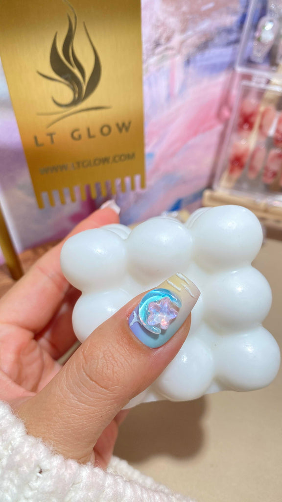 Vibrant and whimsical coffin-shaped press-on nails by LT Glow in yellow and purple, featuring hand-painted star, moon, and butterfly motifs, offering a stylish and artistic design.
