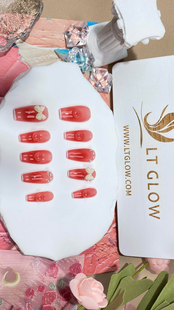 Lush pink hues on LT Glow's Coffin Nails, highlighted with 3D designs, pearls, and handpicked charms for a bespoke look