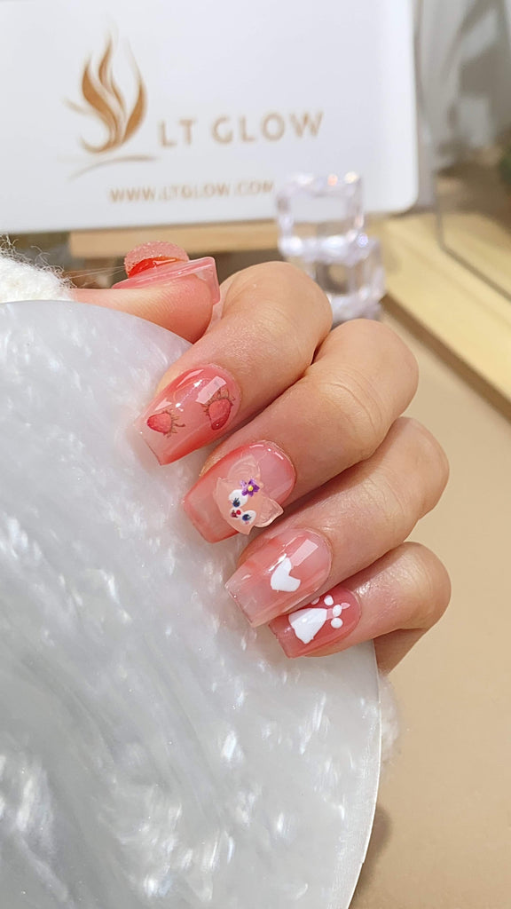 Elegant pink square press-on nails by LT-Glow, adorned with crystal flower and heart accents for a feminine touch